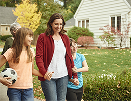 A mom walking with her two young daughters.